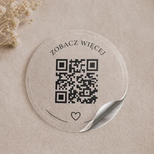 Przezroczysta okrągła naklejka z kodem QR i napisem Zobacz więcej